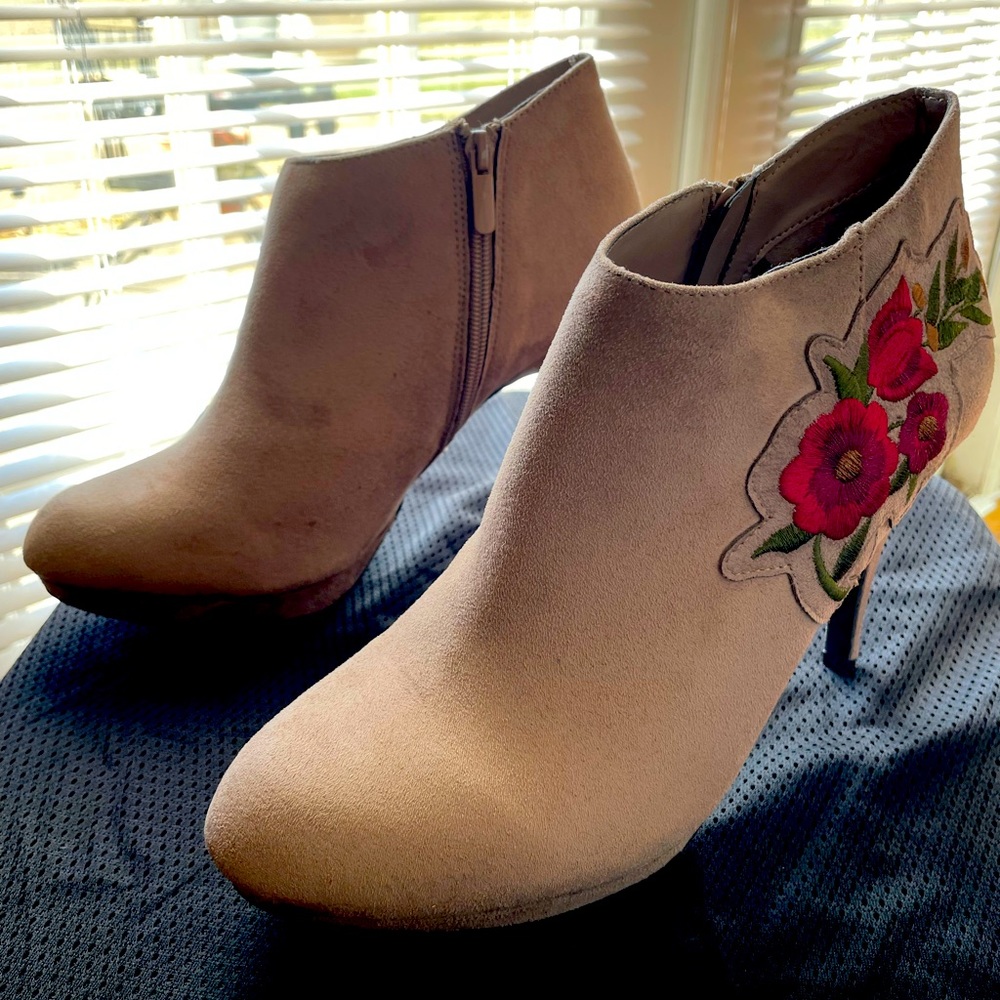 Tan high heeled booties with red floral embroidery.